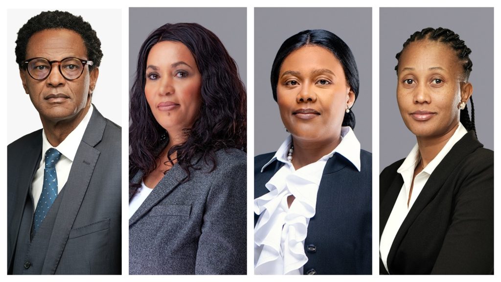 Four individual professional headshots in a row: a man in a suit with glasses; a woman with wavy dark hair; a woman in a white blouse and dark blazer; a woman with braided hair in a black blazer.