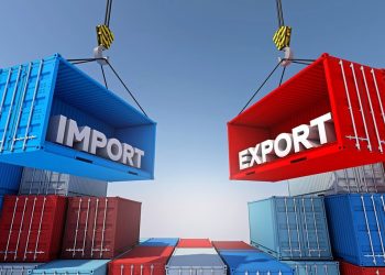 Two large shipping containers labeled IMPORT (blue) and EXPORT (red) are suspended by cranes above stacks of containers, illustrating trade.