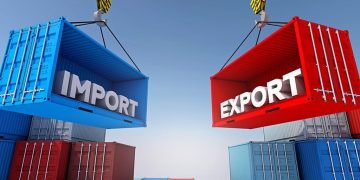 Two large shipping containers labeled IMPORT (blue) and EXPORT (red) are suspended by cranes above stacks of containers, illustrating trade.