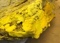 URANIUM1 | Mining and Energy Namibia | Namibia’s Leading Mining & Energy News Rough rock surface covered in bright yellow sulfur mineral deposits.