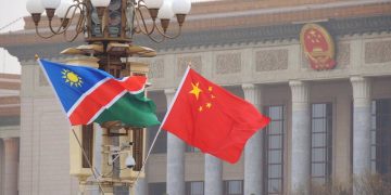 NAMCHINA1 | Mining and Energy Namibia | Namibia’s Leading Mining & Energy News Namibia and China flags waving in front of a government building with columns, signaling international presence.