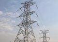WhatsApp Image 2026-05-17 at 75842 AM | Mining and Energy Namibia | Namibia’s Leading Mining & Energy News Industrial high-voltage power transmission tower with multiple wires against a blue sky, illustrating electricity infrastructure the power grid relies on.