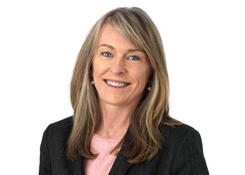 Tara French | Mining and Energy Namibia | Namibia’s Leading Mining & Energy News Professional headshot of a smiling woman in a dark blazer and pink top against a white background.