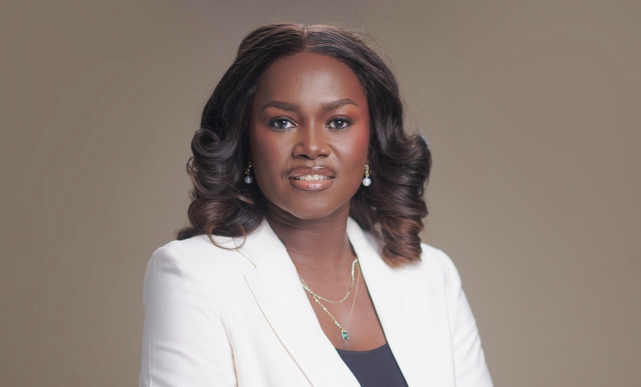 Saave Nakashole | Mining and Energy Namibia | Namibia’s Leading Mining & Energy News Professional portrait of a Black woman with shoulder-length curls, wearing a white blazer and jewelry, against a neutral background.