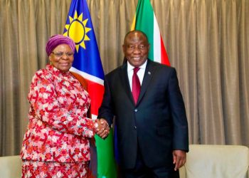 WhatsApp Image 2026-07-20 at 42054 PM | Mining and Energy Namibia | Namibia’s Leading Mining & Energy News Two officials shake hands in front of national flags during a formal meeting, with beige curtains in the background.