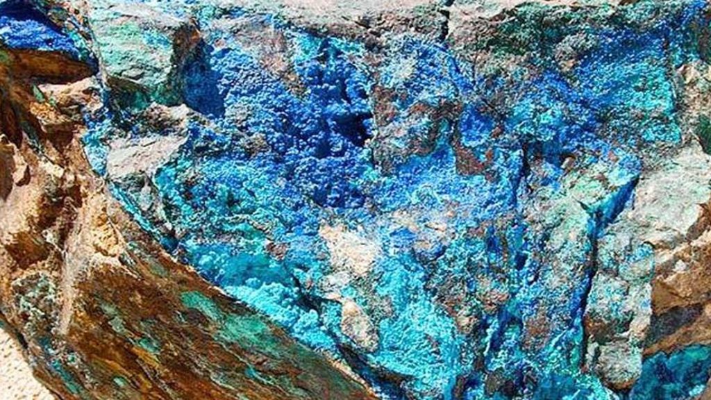 COPPER8 | Mining and Energy Namibia | Namibia’s Leading Mining & Energy News Close-up of a rugged rock surface with vibrant blue and teal mineral colors, likely copper minerals like azurite.