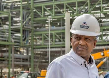 DANGOTE | Mining and Energy Namibia | Namibia’s Leading Mining & Energy News Man wearing a white hard hat with the Dangote Fertilizer logo at an industrial construction site.