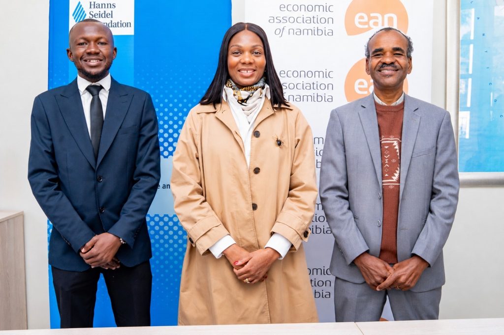 WhatsApp Image 2026-08-02 at 80404 PM | Mining and Energy Namibia | Namibia’s Leading Mining & Energy News Three professionally dressed people posing side by side in front of blue/white banners with logos (Hanns Seidel Foundation and Economic Association of Namibia).