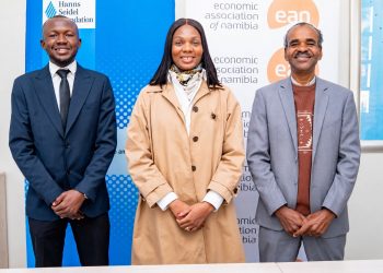 WhatsApp Image 2026-08-02 at 80404 PM | Mining and Energy Namibia | Namibia’s Leading Mining & Energy News Three professionally dressed people posing side by side in front of blue/white banners with logos (Hanns Seidel Foundation and Economic Association of Namibia).