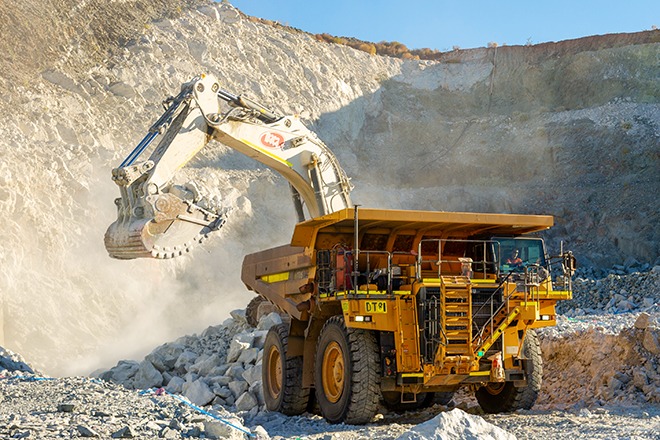 MINING10 | Mining and Energy Namibia | Namibia’s Leading Mining & Energy News Excavator loading rubble into a large mining dump truck at a quarry.