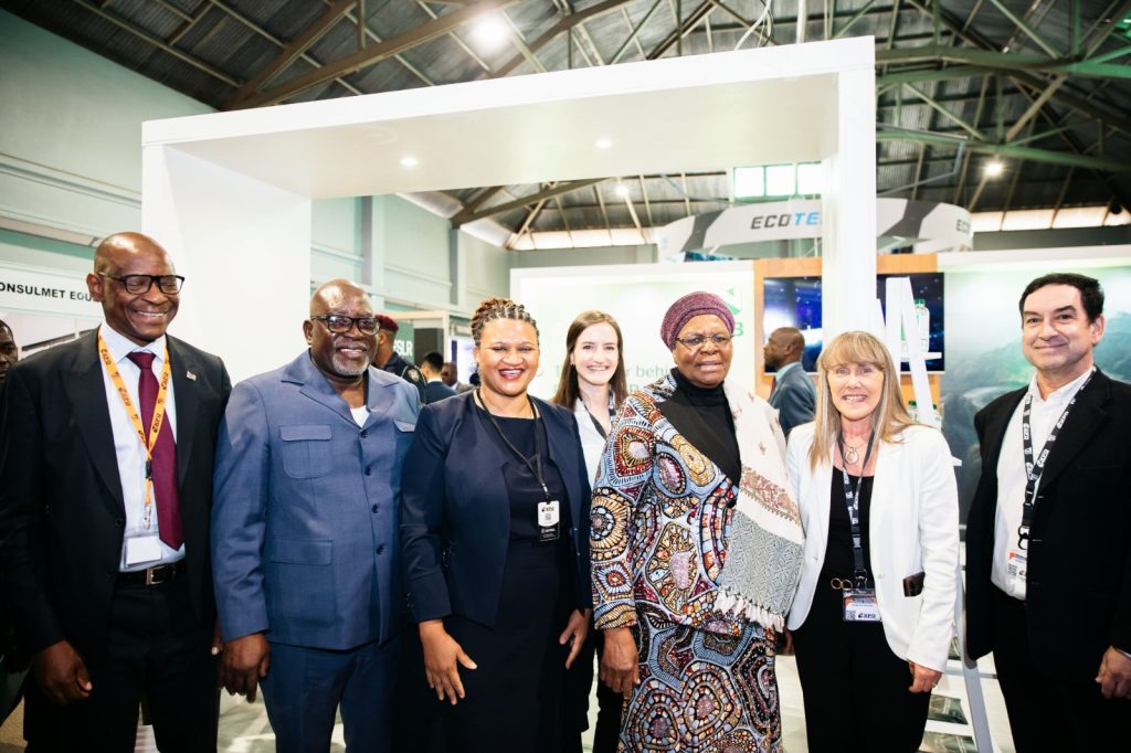 WhatsApp Image 2026-08-06 at 91214 PM | Mining and Energy Namibia | Namibia’s Leading Mining & Energy News Group of professionals at a trade show posing for a photo inside a booth, smiling warmly.