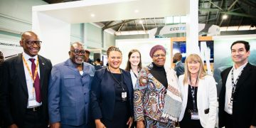 WhatsApp Image 2026-08-06 at 91214 PM | Mining and Energy Namibia | Namibia’s Leading Mining & Energy News Group of professionals at a trade show posing for a photo inside a booth, smiling warmly.