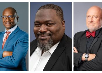 Three men in suits posing for portraits: left in blue suit with red tie, center with beard in a black suit, right in a black suit with a red bow tie on.