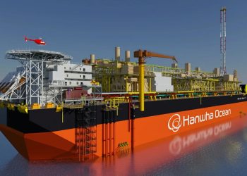 HANWHA OCEAN | Mining and Energy Namibia | Namibia’s Leading Mining & Energy News Large orange and black offshore drilling vessel with yellow scaffolding and a red helicopter overhead, branded Hanwha Ocean on the hull.