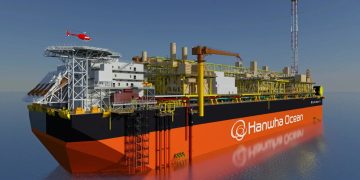 Large orange and black offshore drilling vessel with yellow scaffolding and a red helicopter overhead, branded Hanwha Ocean on the hull.