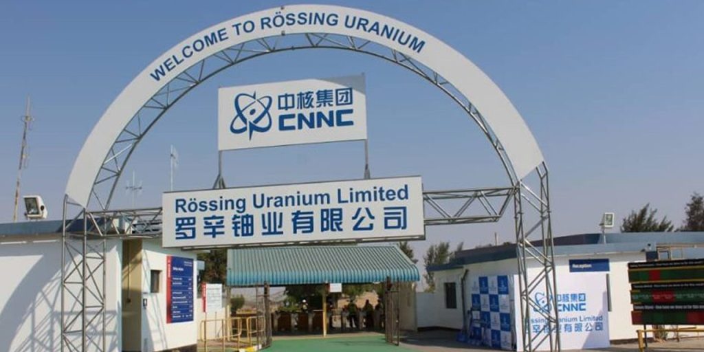 Welcome arch at a uranium mine entrance with signage for Rössing Uranium Limited and ENNC logo in blue.