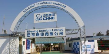 Welcome arch at a uranium mine entrance with signage for Rössing Uranium Limited and ENNC logo in blue.