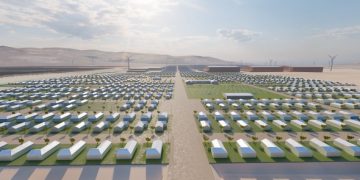 DAURES1 | Mining and Energy Namibia | Namibia’s Leading Mining & Energy News Desert development with hundreds of white rectangular buildings in a grid, a central road, and wind turbines on the horizon.