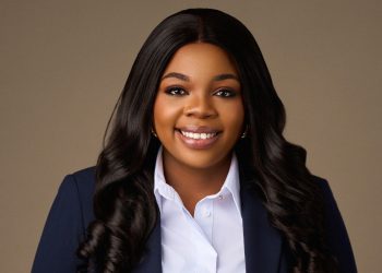 HELENA MBOTI1 | Mining and Energy Namibia | Namibia’s Leading Mining & Energy News Professional headshot of a smiling Black woman with long dark hair in a navy blazer and white shirt.