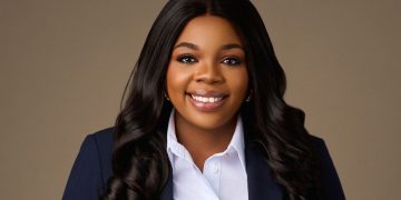 HELENA MBOTI1 | Mining and Energy Namibia | Namibia’s Leading Mining & Energy News Professional headshot of a smiling Black woman with long dark hair in a navy blazer and white shirt.