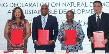 beijing-declaration-on-natural-diamonds-and-sustainable-development-signed-in-beijing-image-5 | Mining and Energy Namibia | Namibia’s Leading Mining & Energy News Four dignitaries stand behind a table, each holding a red folder at a signing ceremony for sustainable development goals in Beijing (Beijing Declaration on Natural Diamonds).