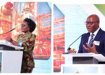MixCollage-26-Sep-2026-07-19-AM-6665 | Mining and Energy Namibia | Namibia’s Leading Mining & Energy News Two speakers at a symposium podium: a woman in a colorful patterned dress speaks on the left, a man in a suit speaks on the right, with conference signage nearby.