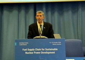 Danie van Aswegen | Mining and Energy Namibia | Namibia’s Leading Mining & Energy News Male speaker in a black suit at a podium during an international conference; banner reads 'Fuel Supply Chain for Sustainable Nuclear Power Development'