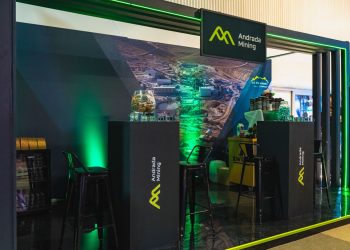 WhatsApp Image 2026-10-23 at 173925 | Mining and Energy Namibia | Namibia’s Leading Mining & Energy News Andrada Mining booth with black podiums, lime logo, green lighting, and a large mining backdrop.