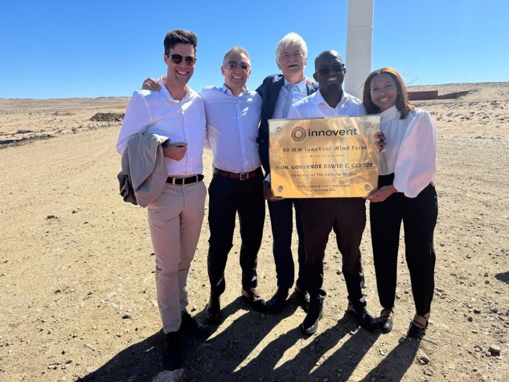 WhatsApp Image 2026-10-27 at 175214 | Mining and Energy Namibia | Namibia’s Leading Mining & Energy News Five people pose outdoors at a wind-farm site, holding a plaque announcing InnoVent Wind Farm (50 MW).